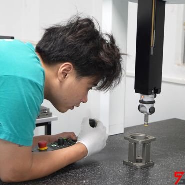 The quality inspector is operating the CMM